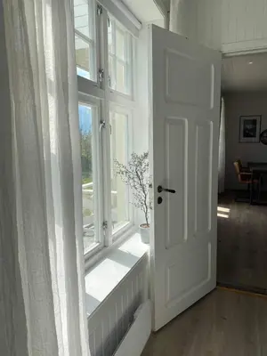 a white door in a room with a window at Valldal Sentrum Overnatting in Valldal