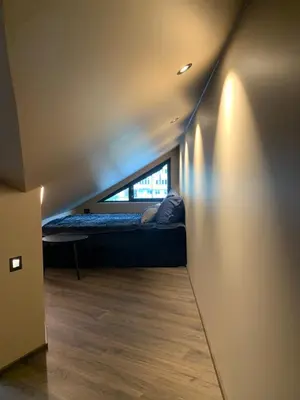 a room with a bed with a window in it at Olden apartments 3, penthouse. in Olden