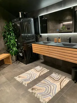 a bathroom with two sinks and a rug on the floor at Olden apartments 3, penthouse. in Olden
