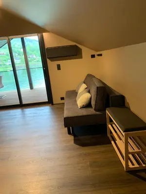 a living room with a couch and a large window at Olden apartments 3, penthouse. in Olden