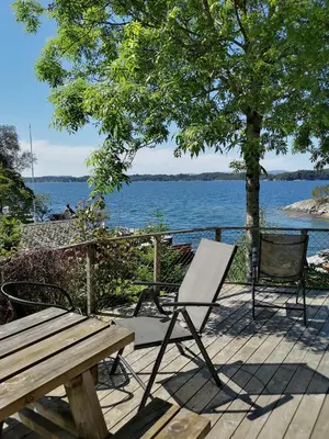 a wooden deck with a picnic table and a bench at Fanafjorden Cabins in Bergen