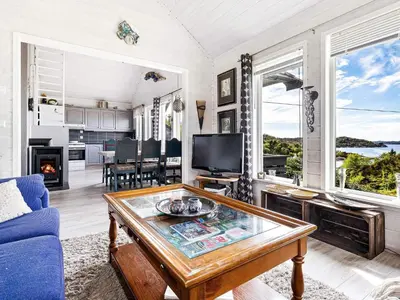 a living room with a blue couch and a table at 6 person holiday home in Ånneland-By Traum in Ånneland