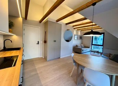 a dining room and living room with a wooden table at Odda City Apartments in Odda