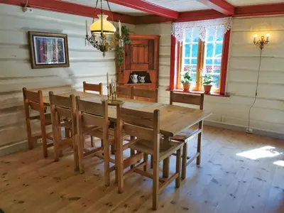 a dining room with a wooden table and chairs at Unique farm stay in the steep mountains of Rjukan in Vemork