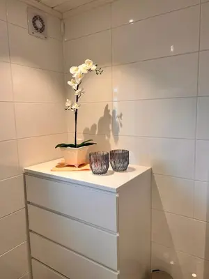 two vases on a shelf with a flower in it at På solsiden av Gaustatoppen in Tuddal