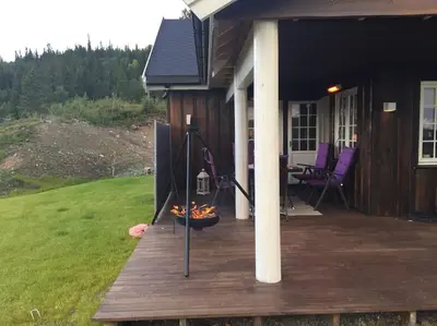 a porch of a house with a grill on it at På solsiden av Gaustatoppen in Tuddal