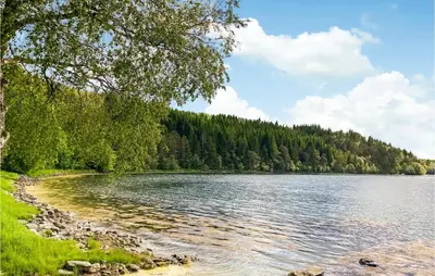 a view of a lake with trees in the background at 4 Bedroom Beach Front Home In Skodje in Skodje