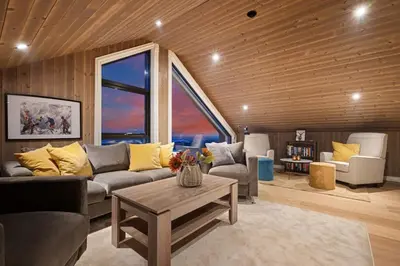 a living room with a couch and a table at Ski-in-out from the door Alpine XC Mountain views in Torvetjørn