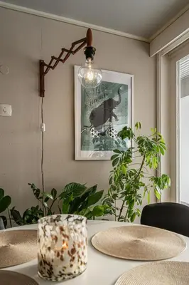 a dining room table with a lamp and a picture at Fjord view apartment in Ålesund with free parking in Ålesund