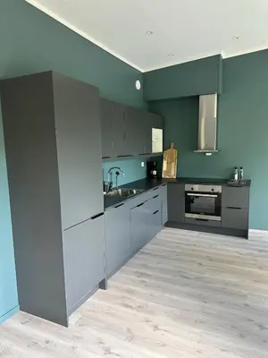 a kitchen with gray cabinets and a sink at Loen Panorama in Stryn