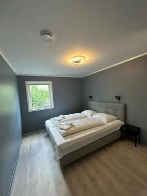 a bedroom with a large bed with a window at Loen Panorama in Stryn