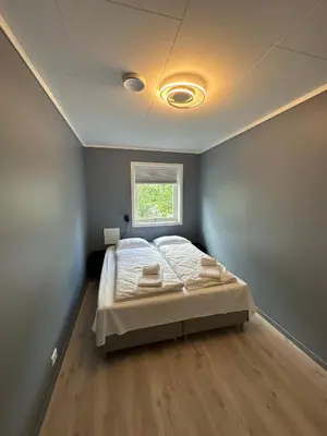 a bedroom with a bed and a window at Loen Panorama in Stryn