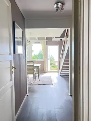 a hallway with a table and a dining room at Moldegaard Farmhouse - Apartment C in Moldegard