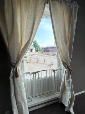a window with a white curtain and a radiator at Moldegaard Farmhouse - Apartment C in Moldegard