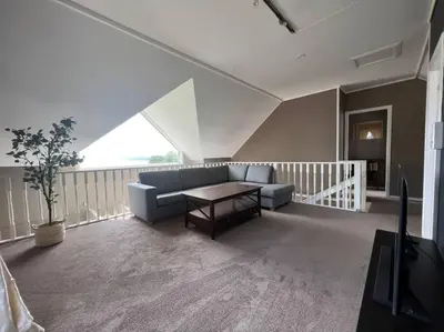 a living room with a couch and a table at Moldegaard Farmhouse - Apartment C in Moldegard