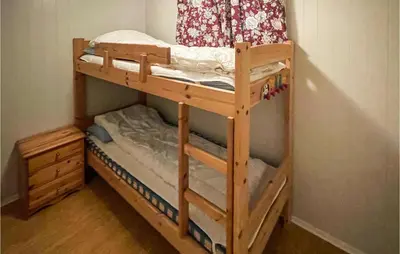 a wooden bunk bed in a corner of a room at Nice Home In Sagstua With Lake View in Linstad