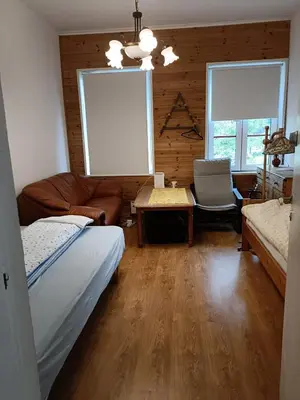 a bedroom with a bed and a couch and a table at Fjordshelter dorm in Tysso