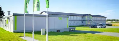 a large building with flags in front of it at Flexbase in Brekstad