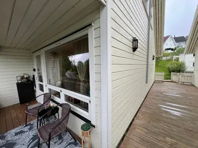 a porch with two chairs and a window on a house at Røstad Apartment - with Kitchen and Free Parking in Trondheim