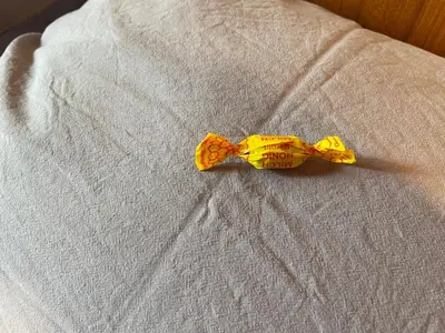 a yellow bow tie sitting on a bed at Kjerkgata 6 - midt i Røros sentrum in Røros