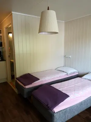 two beds sitting next to each other in a room at Kvamsdal Pensjonat 1 in Eidfjord