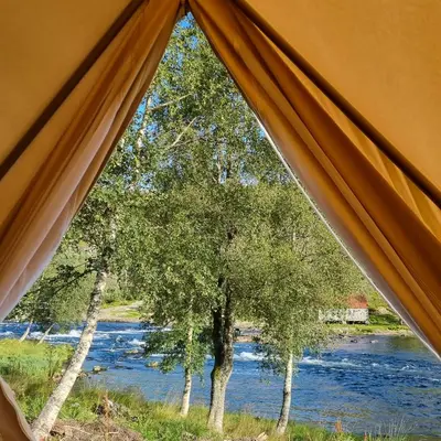 a view of a river from inside a tent at Flatheim Glamping in Viksdalen