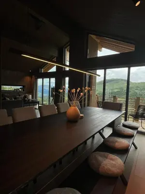 a dining room with a large wooden table and chairs at Sogndal Chalet in Sogndal