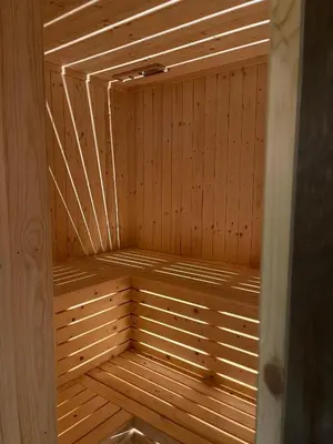 a wooden sauna with wooden paneling on a wooden floor at Sogndal Chalet in Sogndal