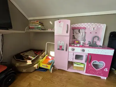 a pink play kitchen and a toy refrigerator at Spacious and beautiful apartment in Geilo, mountain retreat with view! in Geilo
