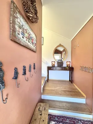 a hallway with a wall with antiques on it at Spacious and beautiful apartment in Geilo, mountain retreat with view! in Geilo
