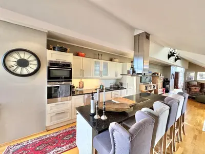 a kitchen with a large island with chairs around it at Spacious and beautiful apartment in Geilo, mountain retreat with view! in Geilo