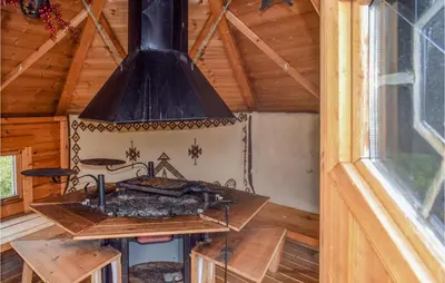 an outdoor stove in a wooden cabin with a window at Amazing Home In Eggedal With Kitchen in Eggedal
