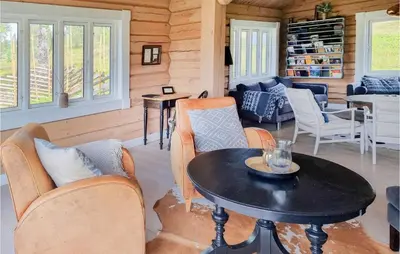 a living room with a table and chairs at 5 Bedroom Gorgeous Home In Tynset in Tynset