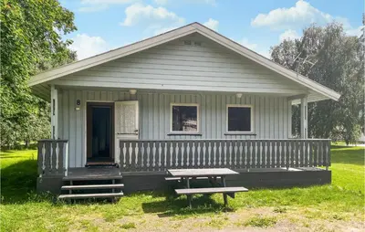 a small house with a picnic table in front of it at 2 Bedroom Stunning Home In Dovre in Dovre