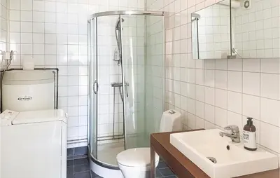 a bathroom with a shower and a toilet and a sink at 2 Bedroom Stunning Home In Dovre in Dovre