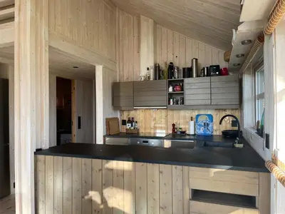 a kitchen with a black counter top in a room at Veslestølen - Ålhytte with amazing view, 1000 meter in Ål