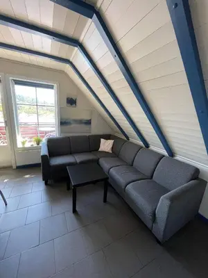 a living room with a couch and a table at Nautnes Seaside Apartments A5 in Nautnes