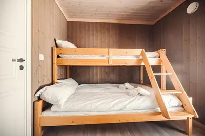 a bunk bed with a ladder in a room at Harevadet 211 in Hornindal
