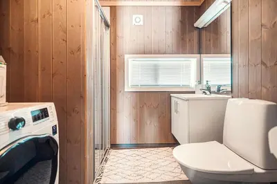 a bathroom with a toilet and a sink at Harevadet 211 in Hornindal