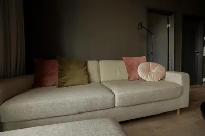 a couch with pillows on it in a living room at Elegant apartment in Trysil Alpine Lodge in Trysil