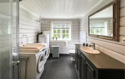 a bathroom with a sink and a washing machine at 4 Bedroom Beautiful Home In Nord-Torpa in Nord Torpa