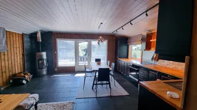 a kitchen with a table and chairs in a room at Skurdalsvegen 37L in Geilo