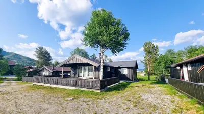 a house with a tree in front of it at Skurdalsvegen 37L in Geilo