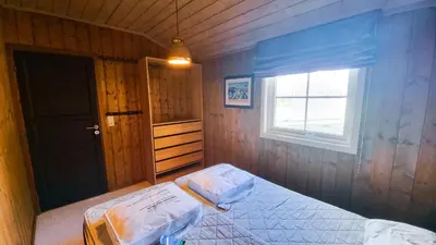 a small bedroom with a bed and a window at Skurdalsvegen 37L in Geilo