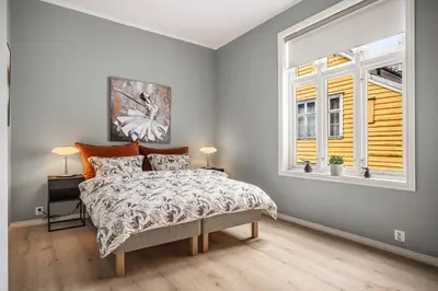 a bedroom with a bed and a window at Corner Apartments in Bergen