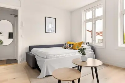 a living room with a couch and a table at Dinbnb Apartments I Views & Street Parking in Sandviken in Bergen