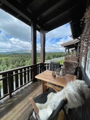 a deck with a wooden table and a wooden tableablish at Leilighet i vakre Rauland in Rauland