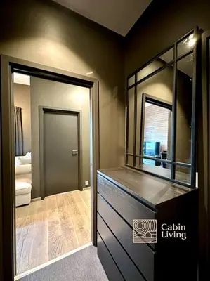 a bathroom with a vanity with a mirror and a door at New high standard apartment in Trysil with ski in out in Trysil