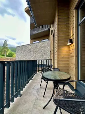 a balcony with tables and chairs on a building at New high standard apartment in Trysil with ski in out in Trysil