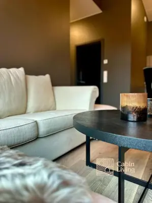 a living room with a couch and a table at New high standard apartment in Trysil with ski in out in Trysil